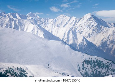 A beautiful view of a big snowy mountain range with a blue sky. - Powered by Shutterstock