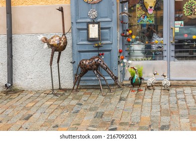 Beautiful view of birds figures as decoration of entrance to old building. Sweden. Uppsala. 05.14.2022.