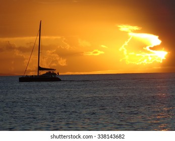 Beautiful View Of A Boat Sailing At Sunset In Maui Hawaii