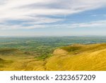 A beautiful view of Brecon Beacons mountain range from the top of a hill in Wales. A beautiful sunny day where you can see very far.