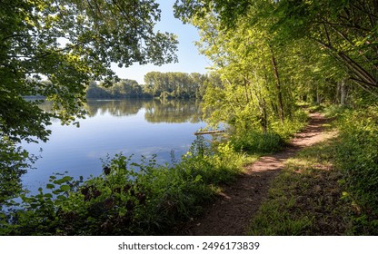 Beautiful view of the Carandeau fishing pond in summer located in the commune of Choisy-au-Bac, in the department of Oise, in the Hauts-de-France region.