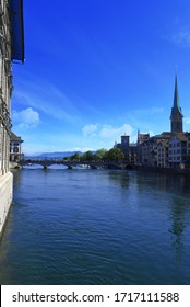 Beautiful View Of Fraumünster Church And St. Peter And River Limmat At Lake Zurich On A Sunny Day With Clouds In Summer