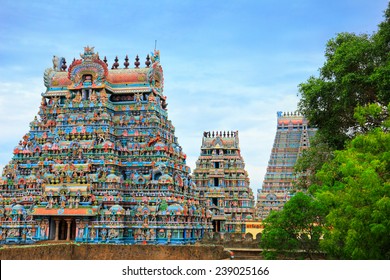 Beautiful view of colorful gopura in the Hindu Jambukeswarar Temple against the background of cloudy blue sky in Trichy (Tiruchirapalli), Tamil Nadu, South India