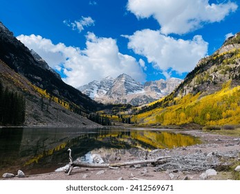 A beautiful view of Crater Lake Trail at Maroon Bells mountains with blue cloudy sky - Powered by Shutterstock