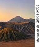 Beautiful view of crater of Mount Bromo, Mount Semeru and Mount Batok in Java island, Indonesia, during a colorful sunrise