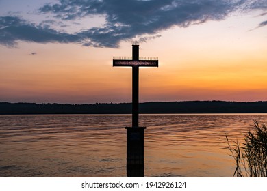 A beautiful view of cross on Lake Starnberg with sunset background in Germany, Bavaria