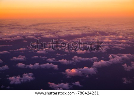 Beautiful view  of cumulus clouds with sunset at atmosfera from airplain window