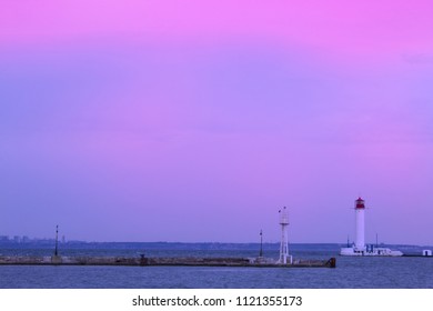 Beautiful view. The current lighthouse. Vorontsov lighthouse in Odessa against the background of the Black Sea, closeup. White tower with a red cabin at the top on a background of blue seascape