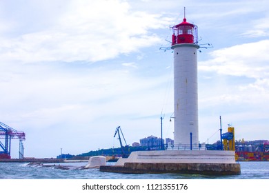Beautiful view. The current lighthouse. Vorontsov lighthouse in Odessa against the background of the Black Sea, closeup. White tower with a red cabin at the top on a background of blue seascape