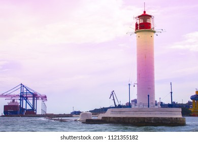 Beautiful view. The current lighthouse. Vorontsov lighthouse in Odessa against the background of the Black Sea, closeup. White tower with a red cabin at the top on a background of blue seascape