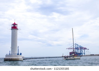 Beautiful view. The current lighthouse. Vorontsov lighthouse in Odessa against the background of the Black Sea, closeup. White tower with a red cabin at the top on a background of blue seascape