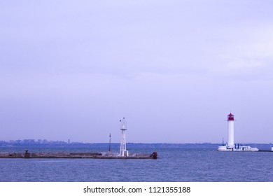 Beautiful view. The current lighthouse. Vorontsov lighthouse in Odessa against the background of the Black Sea, closeup. White tower with a red cabin at the top on a background of blue seascape