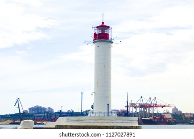 Beautiful view. The current lighthouse. Vorontsov lighthouse in Odessa against the background of the Black Sea, closeup. White tower with a red cabin at the top on a background of blue seascape