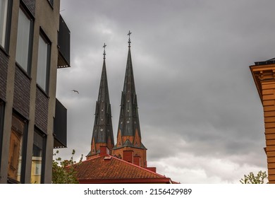 Beautiful view of domes of famous Uppsala Cathedral against stormy sky. Sweden. Europe.