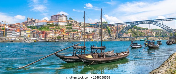 Beautiful view of Douro River with the traditional Rabelo wine boats and the Dom Luis I Bridge - Porto, Portugal