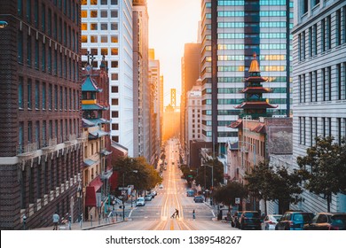 Beautiful view of downtown San Francisco with famous California Street illuminated in first golden morning light at sunrise in summer, San Francisco, California, USA