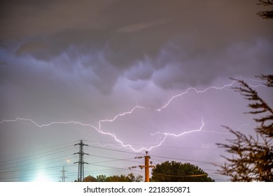 Beautiful View Of Dramatic Dark Stormy Sky And Lightning Over The City In Purple Light.