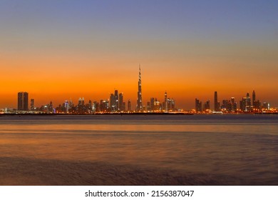Beautiful view of the Dubai skyline in UAE from Dubai creek Harbour.Panoramic view of a big futuristic city by night. Business bay, Dubai, United Arab Emirates. Nighttime skyline. Dusk Skyline.