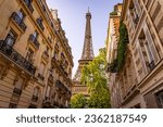 Beautiful view to the Eiffel Tower in Paris between the typical mansions - travel photography in Paris France