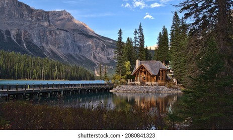 Beautiful view of Emerald Lake in Yoho National Park, British Columbia, Canada in the afternoon light with wooden lodge building and bridge in autumn season in the Rocky Mountains with grass in front. - Shutterstock ID 2080841323