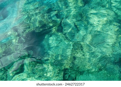 Beautiful view of the emerald water with a rocky bottom in the sea. - Powered by Shutterstock