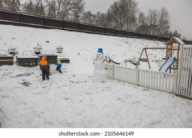 Beautiful View Of The Family Playing In The Backyard. Winter Activities Concept. Sweden.