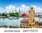 Beautiful view of famous Hamburger Landungsbruecken with harbor and traditional paddle steamer on Elbe river, St. Pauli district, Hamburg, Germany