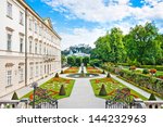 Beautiful view of famous Mirabell Gardens with Mirabell Palace and the old historic Fortress Hohensalzburg in the background in Salzburg, Austria