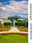 Beautiful view of famous Mirabell Gardens with the old historic Fortress Hohensalzburg in the background in Salzburg, Austria. Famous Mirabell Gardens with historic Fortress in Salzburg, Austria.