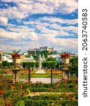 Beautiful view of famous Mirabell Gardens with the old historic Fortress Hohensalzburg in the background in Salzburg, Austria. Famous Mirabell Gardens with historic Fortress in Salzburg, Austria.