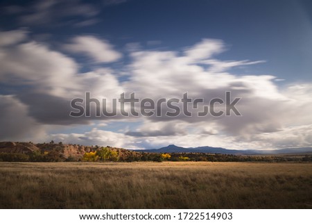 A beautiful view of the fields under the cloudy sky in Ghost Ranch, New Mexico