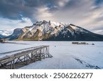 Beautiful view of frozen Lake Minnewanka with rocky mountains in winter at Banff national park, Alberta, Canada