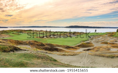 a beautiful view of a golf course at sunset