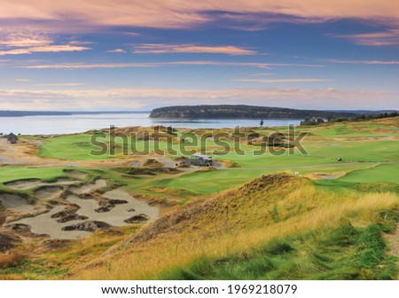 a beautiful view of a golf course at sunset