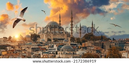 Beautiful view of gorgeous historical Suleymaniye Mosque, Rustem Pasa Mosque and buildings in front of dramatic sunset. Istanbul most popular tourism destination of Turkey. Travel Turkey concept. 