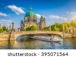 Beautiful view of historic Berlin Cathedral (Berliner Dom) at famous Museumsinsel (Museum Island) with excursion boat on Spree river in beautiful evening light at sunset in summer, Berlin, Germany