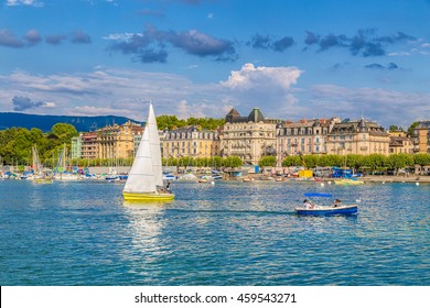 Beautiful view of the historic city center of Geneva with boats on Lake Geneva in the harbor in beautiful evening light at sunset with blue sky and clouds in summer, Canton of Geneva, Switzerland