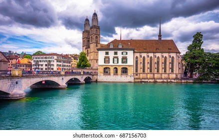 Beautiful view of historic city center of Zurich with famous Fraumunster Church and Munsterbucke crossing river Limmat on a sunny day with blue sky and clouds in summer, Canton of Zurich, Switzerland