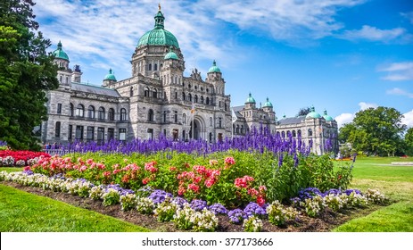 Beautiful view of historic parliament building in the citycenter of Victoria with colorful flowers on a sunny day, Vancouver Island, British Columbia, Canada
