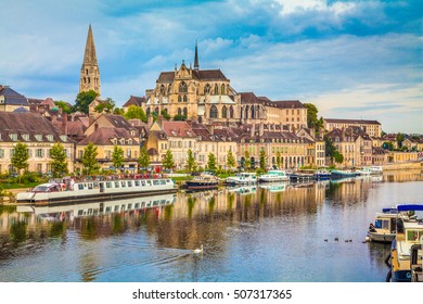 Beautiful view of the historic town of Auxerre with Yonne river on a sunny day with blue sky and clouds in summer, Burgundy, France
