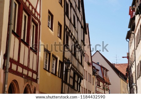 Beautiful View Of Historical Nuremberg City At Sunny Day. Historic Highlights of Germany. Nuremberg is the birthplace of Albrecht Duerer and Johann Pachelbel. Red-Yellow And Blue Background. 