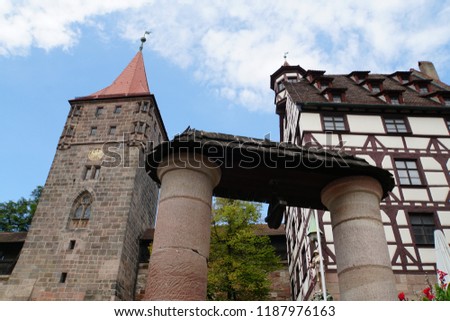 Beautiful View Of Historical Nuremberg City With Old Well At Sunny Day. Background Of Historic Highlights of Germany. Nuremberg is the birthplace of Albrecht Duerer and Johann Pachelbel. 
