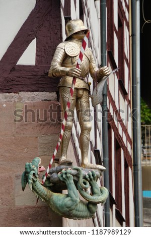Beautiful View Of Historical Nuremberg City With Medieval Figure. Historic Highlights of Germany. Nuremberg is the birthplace of Albrecht Duerer and Johann Pachelbel. Red-Brown And White Background. 