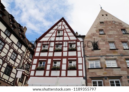 Beautiful View Of Historical Nuremberg City At Sunny Day. Historic Highlights of Germany. Nuremberg is the birthplace of Albrecht Duerer and Johann Pachelbel. Red-Brown And White Background. 