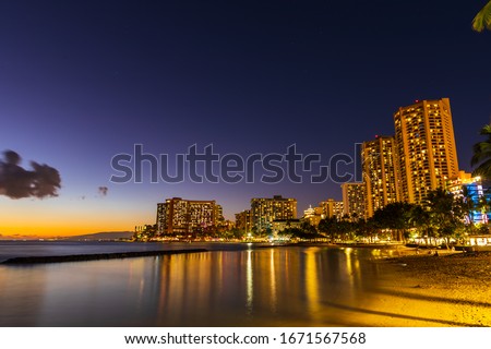 Beautiful view of Honolulu skyline and Waikiki beach at night in the island of Oahu, Hawaii, USA. Long exposure shot.