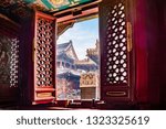Beautiful view from inside the temple through the window on the temple Yonghegong - Lama temple in Beijing, China. It is one of the largest Tibetan Buddhist monasteries in the world