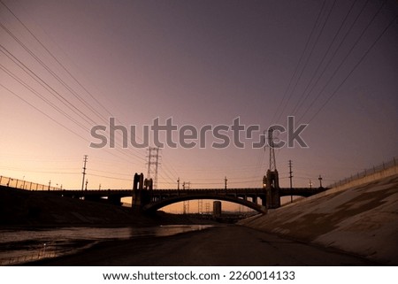A Beautiful view of LA river with 6th street bridge against sunset