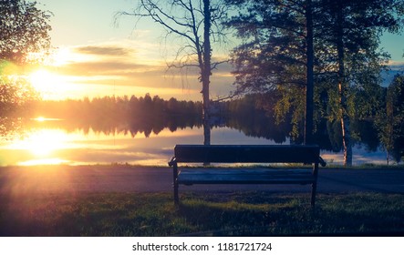 Beautiful View At Lake Päijänne With A Bench At Sunset In Summer