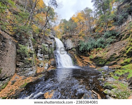 Beautiful view of the main waterfall surrounded by stunning fall foliage near Bushkill Falls, Pennsylvania, U.S.A