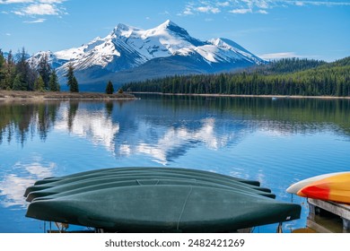 Beautiful view of Maligne Lake smooth water surface with snow capped mountain at the back, in Jasper National Park, Alberta, Canada - Powered by Shutterstock